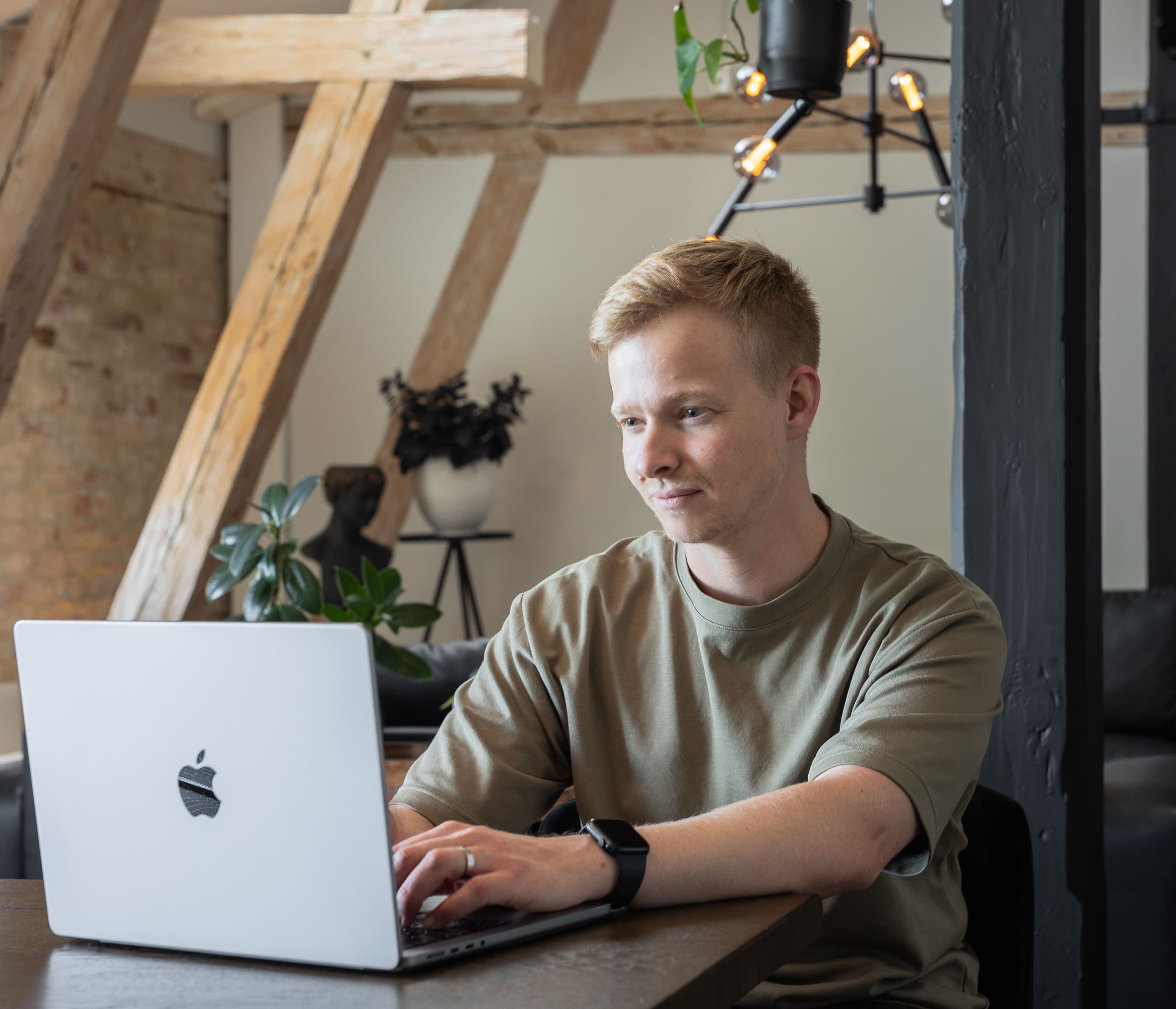 Developer, Joel, working on his macbook pro at the office.